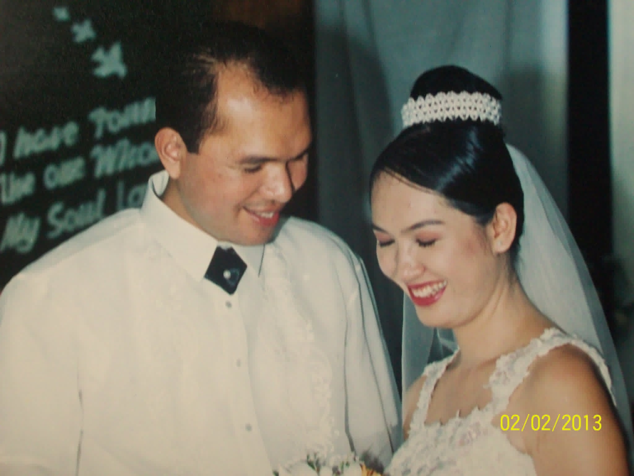 A smiling bride and groom photographed together during their wedding.